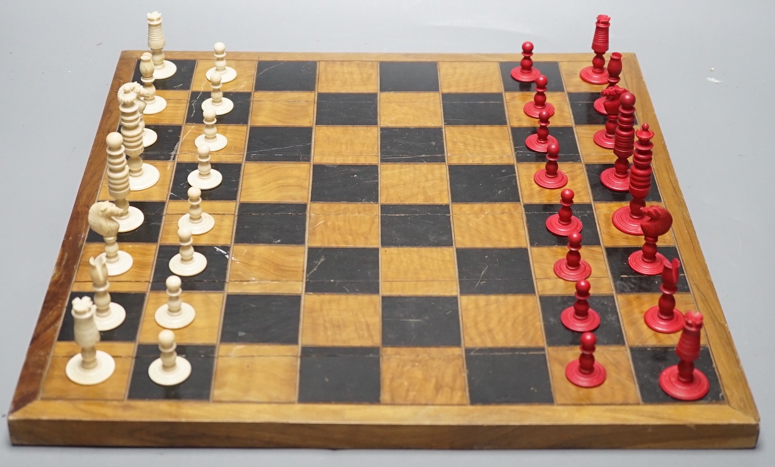 A 19th century bone chess set, Kings 7 cm with a later inlaid chessboard chess board